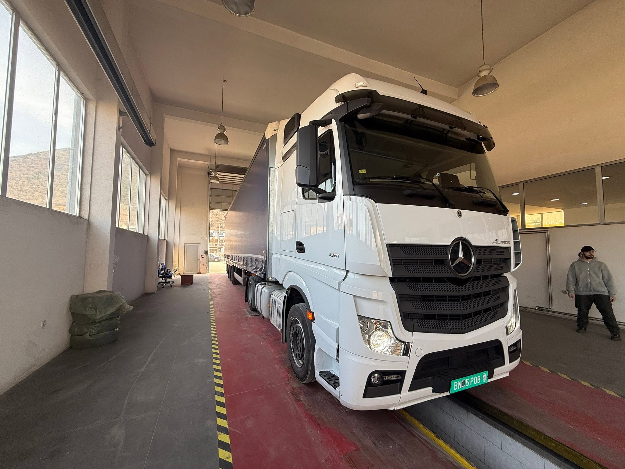 White VALK truck inside a depot with a team member nearby